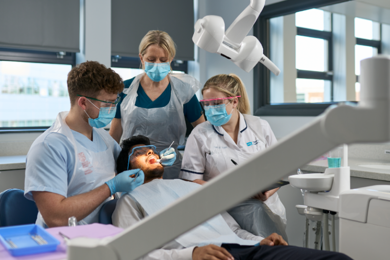 A group of QUB Dentistry Students working on a patient